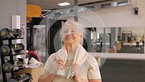 Portrait old woman in gym. Physical culture for older people. Training and individual courses. Happy people smile,