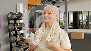 Portrait old woman in gym. Physical culture for older people. Training and individual courses. Happy people smile, sport