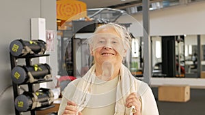 Portrait old woman in gym. Physical culture for older people. Training and individual courses. Happy people smile, sport