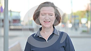 Portrait of Old Woman Smiling at Camera Outdoor