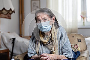 Portrait of old woman wearing surgical mask