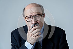 Portrait of older adult man with sad and worried expression suffering from depression