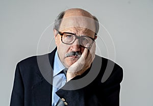 Portrait of older adult man with sad and worried expression suffering from depression