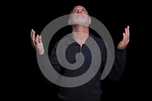 portrait of older bearded man pensive and watching isolated on black background