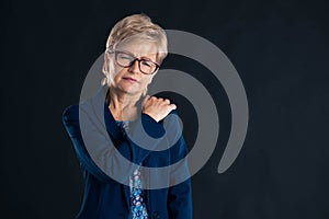 Portrait of an older businesswoman having shoulder pain
