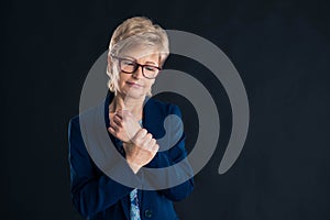 Portrait of an older businesswoman having wrist joint pain