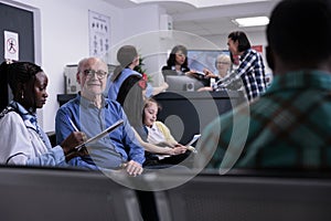 Portrait of older man with african american medical doctor looking at patient data