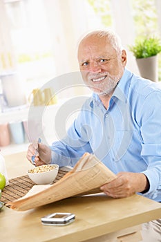 Portrait of older man at breakfast table