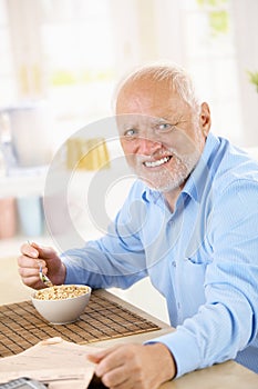 Portrait of older man eating cereal