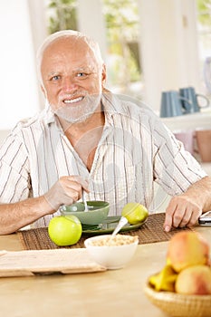 Portrait of older man having morning tea