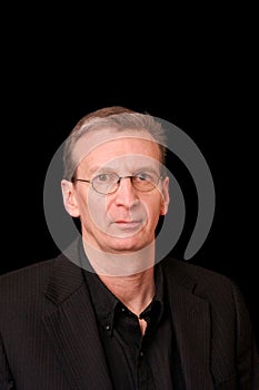 Portrait of older white man on black background