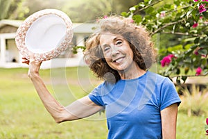 Portrait of an older woman outside his house on the warm center equator