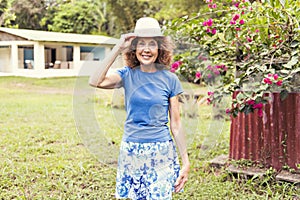 Portrait of an older woman outside his house on the warm center equator