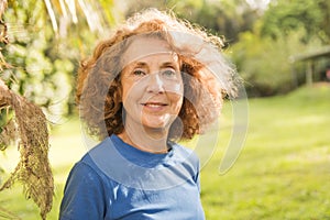 Portrait of an older woman outside his house on the warm center equator