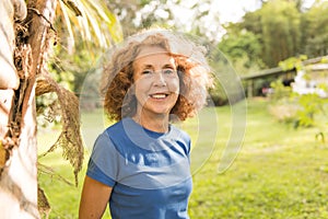 Portrait of an older woman outside his house on the warm center equator