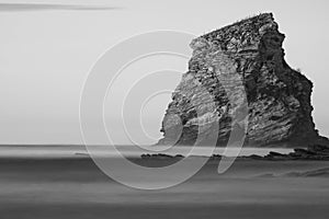 Portrait of one cliff rock of deux jumeaux in hendaye in black and white, isolated, basque country, france