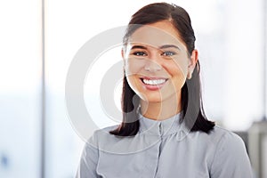 Portrait of one confident young caucasian businesswoman standing in an office. Ambitious entrepreneur and determined