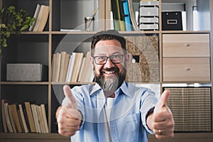 Portrait of one happy and cheerful man smiling and looking at the camera with finger`s hand up. Male person businessman having fu