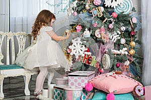 Portrait of one little Caucasian cute blonde girl in the festive New year studio room