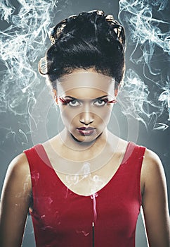 Mixed race woman holding burning incense stick