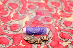 Portrait of one purple thread and button
