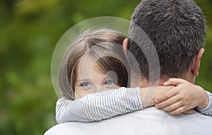 Portrait of  one sad daughter hugging her father