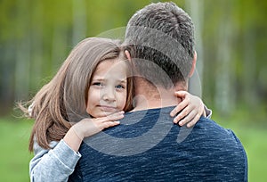 Portrait of one  sad daughter hugging her father
