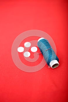 Portrait of one sewing thread with needle and button
