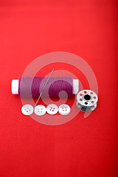 Portrait of one thread, needle, bobbin and button