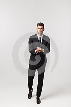 Portrait onfident young handsome businessman or model looking at camera isolated on white background