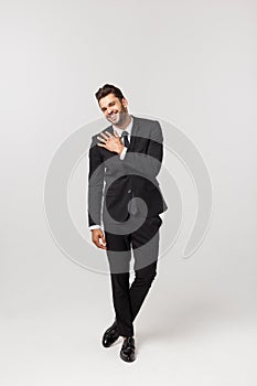 Portrait onfident young handsome businessman or model looking at camera isolated on white background