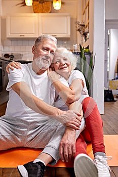 portrait of optimistic sportive man and woman 50-60 years old