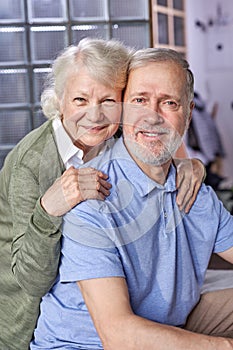 portrait of optmistic caucasian senior man and woman looking at camera smiling