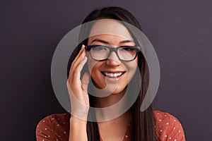 Portrait, optometry and woman with glasses, happiness or person on grey studio background. Face, model or girl with