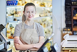 Portrait Ot Teenage Girl Working In Delicatessen Food Shop As Job Experience