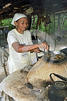 Portrait of outdoor cooking senior woman, Brazil