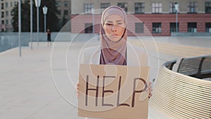 Portrait outdoors young upset oriental Indian woman in hijab student unemployed stressful female worker standing outdoor