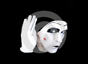 Portrait of overhearing mime in white gloves
