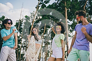 Portrait of overjoyed positive fellows enjoy hanging out dancing forest party weekend outdoors