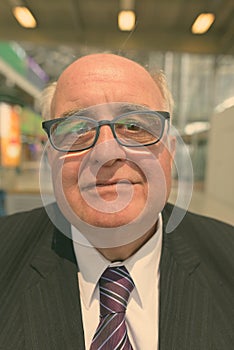 Portrait of overweight senior businessman at the airport