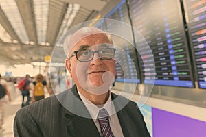 Portrait of overweight senior businessman at the airport