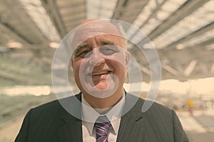 Portrait of overweight senior businessman at the airport