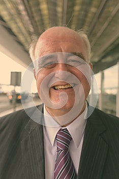 Portrait of overweight senior businessman at the airport
