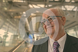 Portrait of overweight senior businessman at the airport