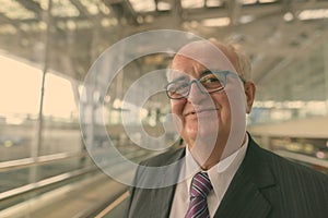 Portrait of overweight senior businessman at the airport