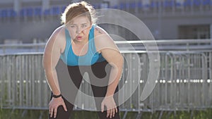 Portrait of overweight woman runner during break