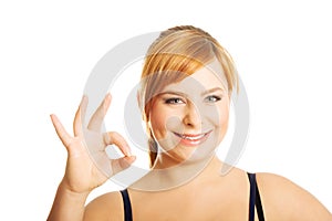 Portrait of overweight woman showing OK sign photo