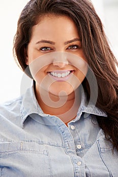 Portrait Of Overweight Woman Sitting On Sofa