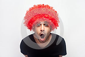 Portrait of overwhelmed shocked man staring in surprise at camera, screaming in amazement and delight. white background