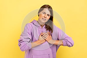 Woman frowning suffering sudden heart attack, myocardial infarction, risk of breast.